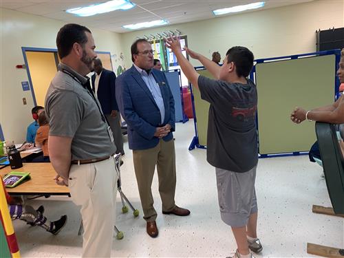 Student talking with Superintendent Dr. Ed Nichols and Board President Tim Holtcamp